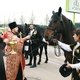 Окропление лошадей святой водой после праздничного молебна